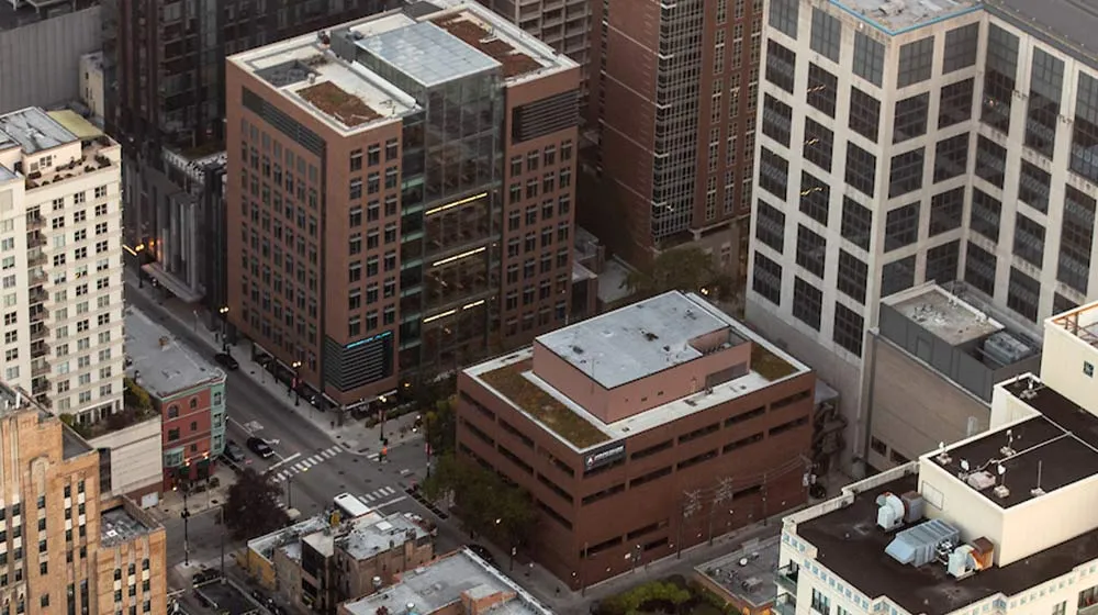 Aerial view of the Schreiber Center and Maguire Hall at Loyola University Chicago's Water Tower Campus, surrounded by city buildings.