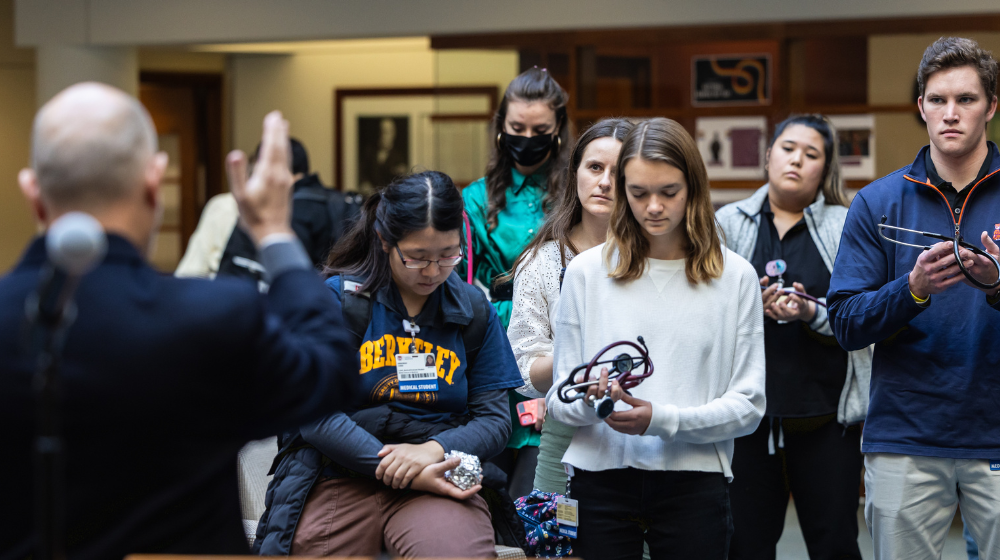 Loyola Stritch students gather for a blessing of their stethoscopes.