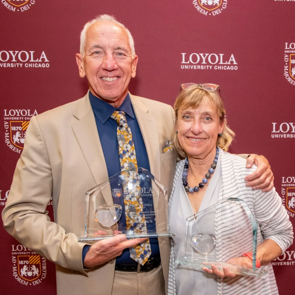Susan (BS '76) and John Dewan (BS '76) accept the 2026 Heart of Loyola Award.