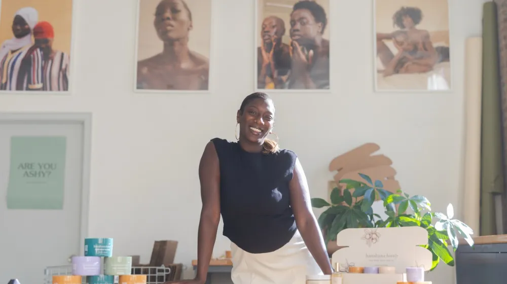 An alum posing in their local-owned business.
