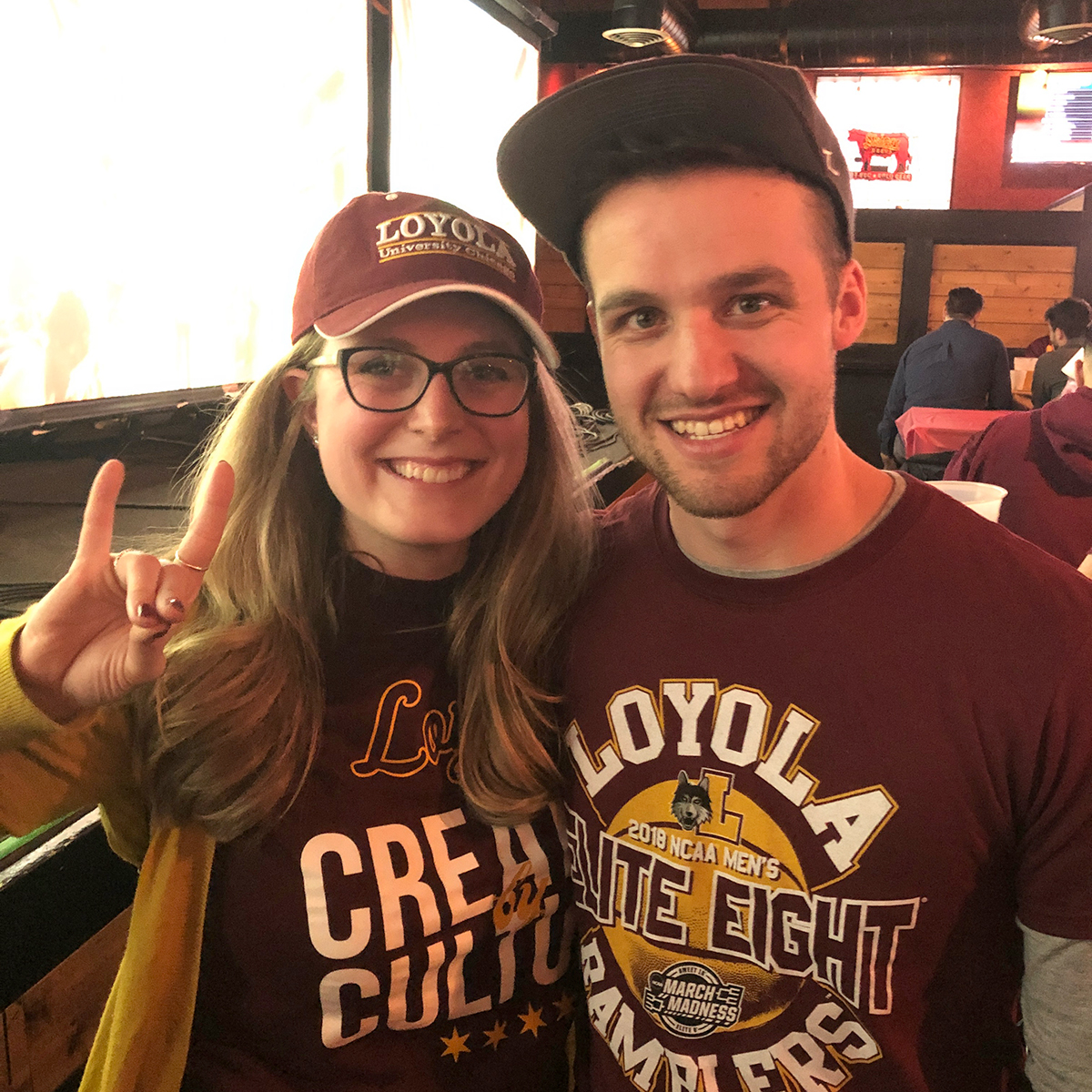 Photo of alumni Anna and Dan Ziemniak in Loyola Athletics tee shirts and caps Photo of alumni Anna and Dan Ziemniak in Loyola Athletics tee shirts and caps