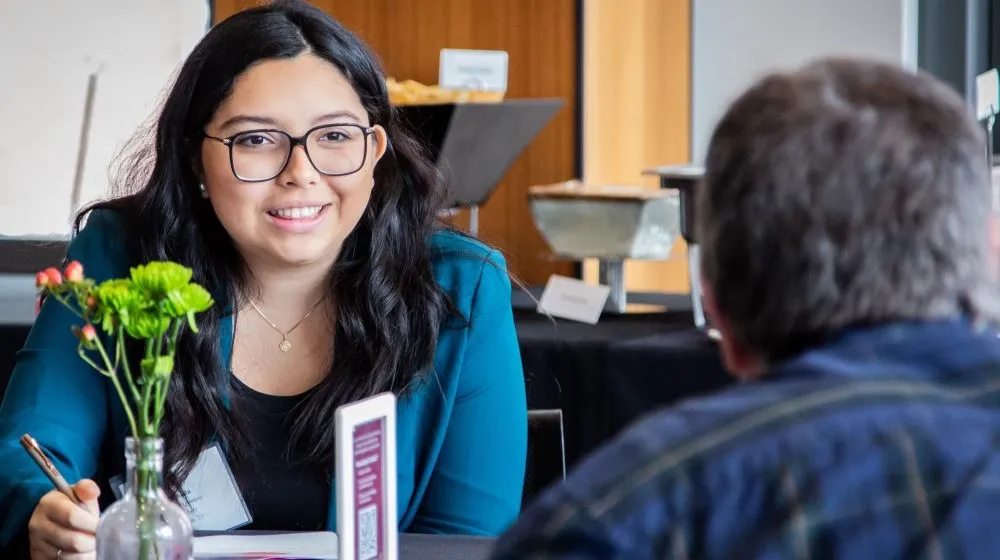 Alumni chat with current students.
