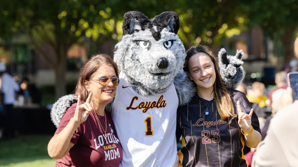 Students pose with Loyola mascot, LU Wolf.