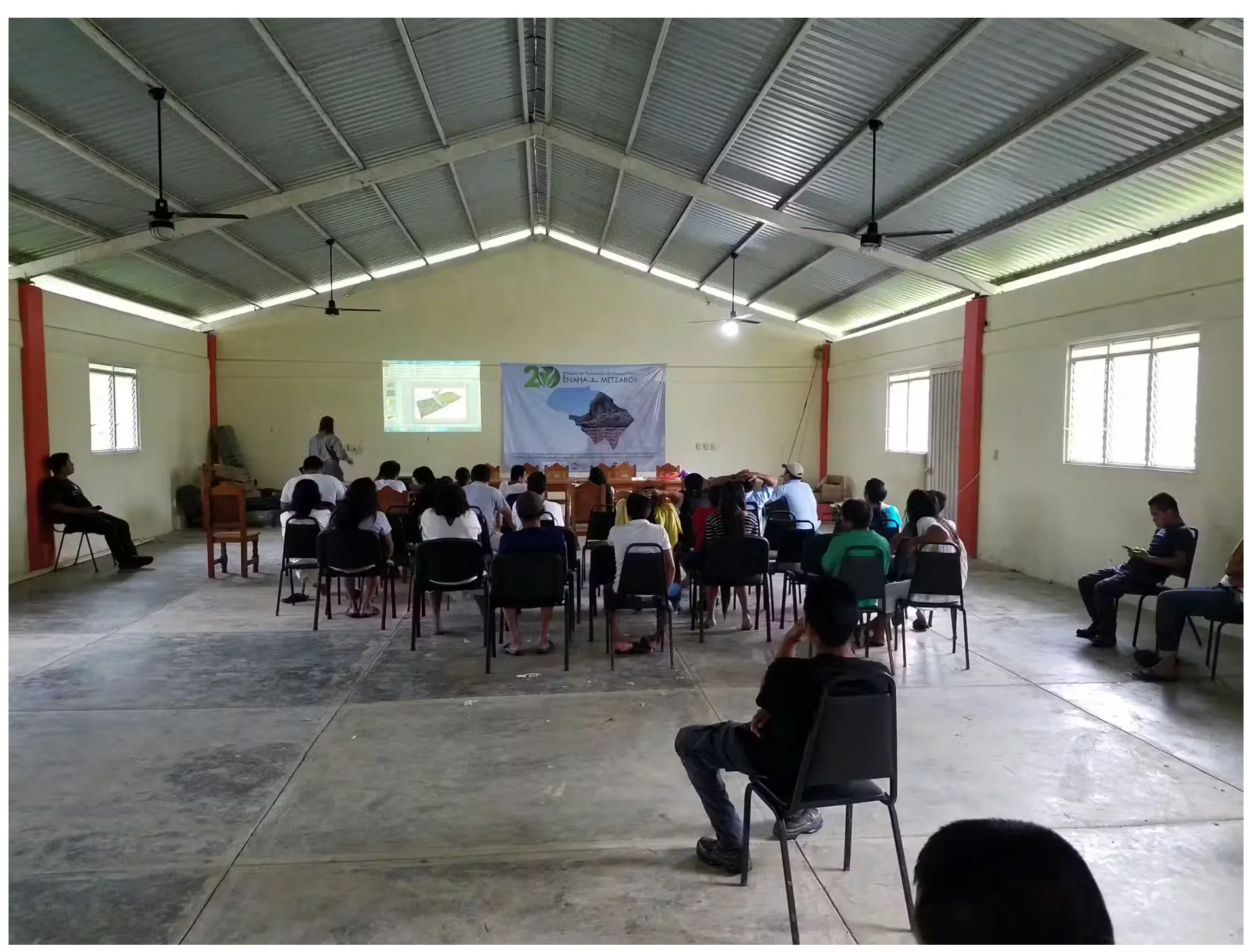room full of people watching a presentation