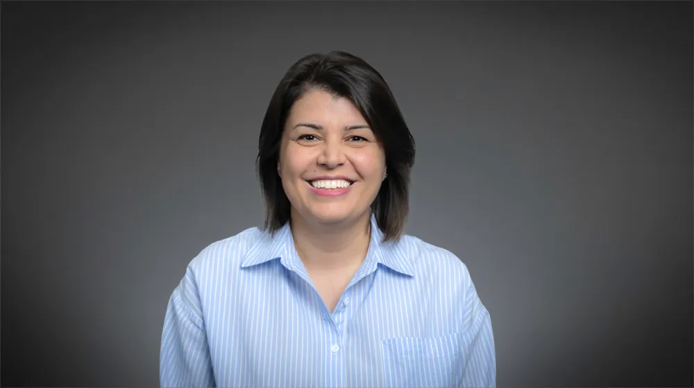 Woman in a light blue blouse smiling Woman in a light blue blouse smiling