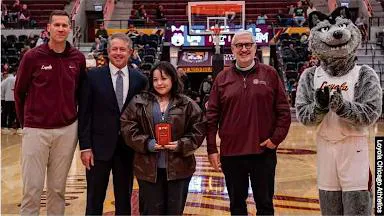 Arrupe student receiving award at basketball game
