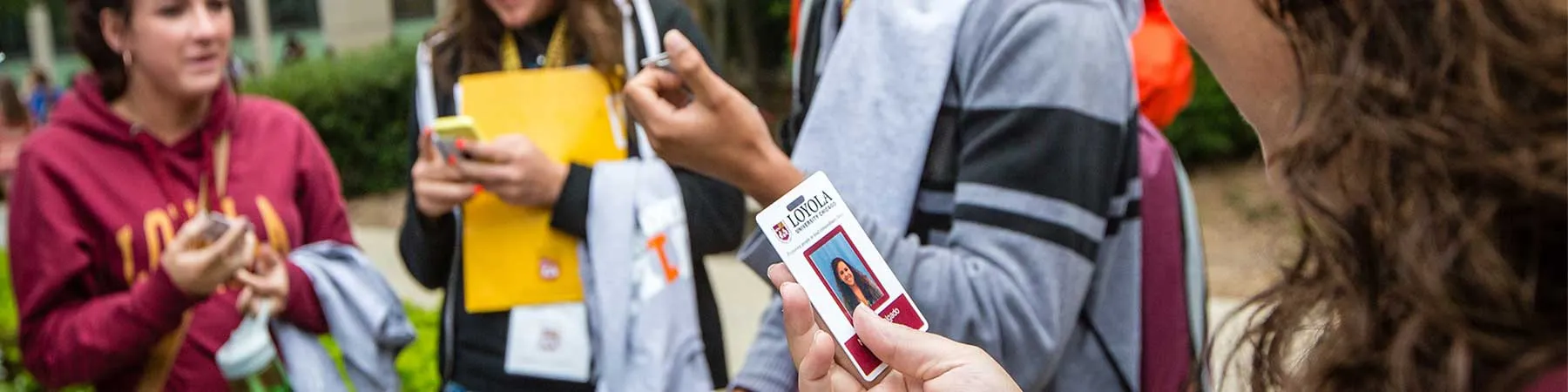 Loyola University Chicago students look at a Student ID card.