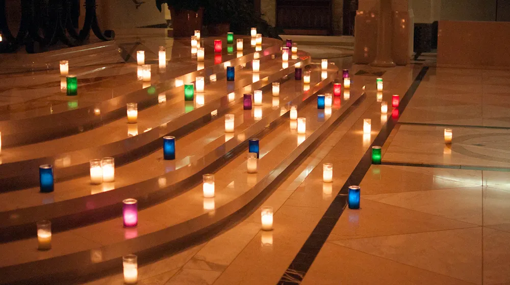 colorful candles lit on marble steps