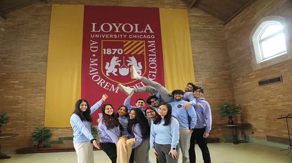 Group of students clustered together smiling