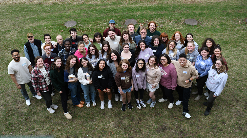 Group of students clustered together smiling