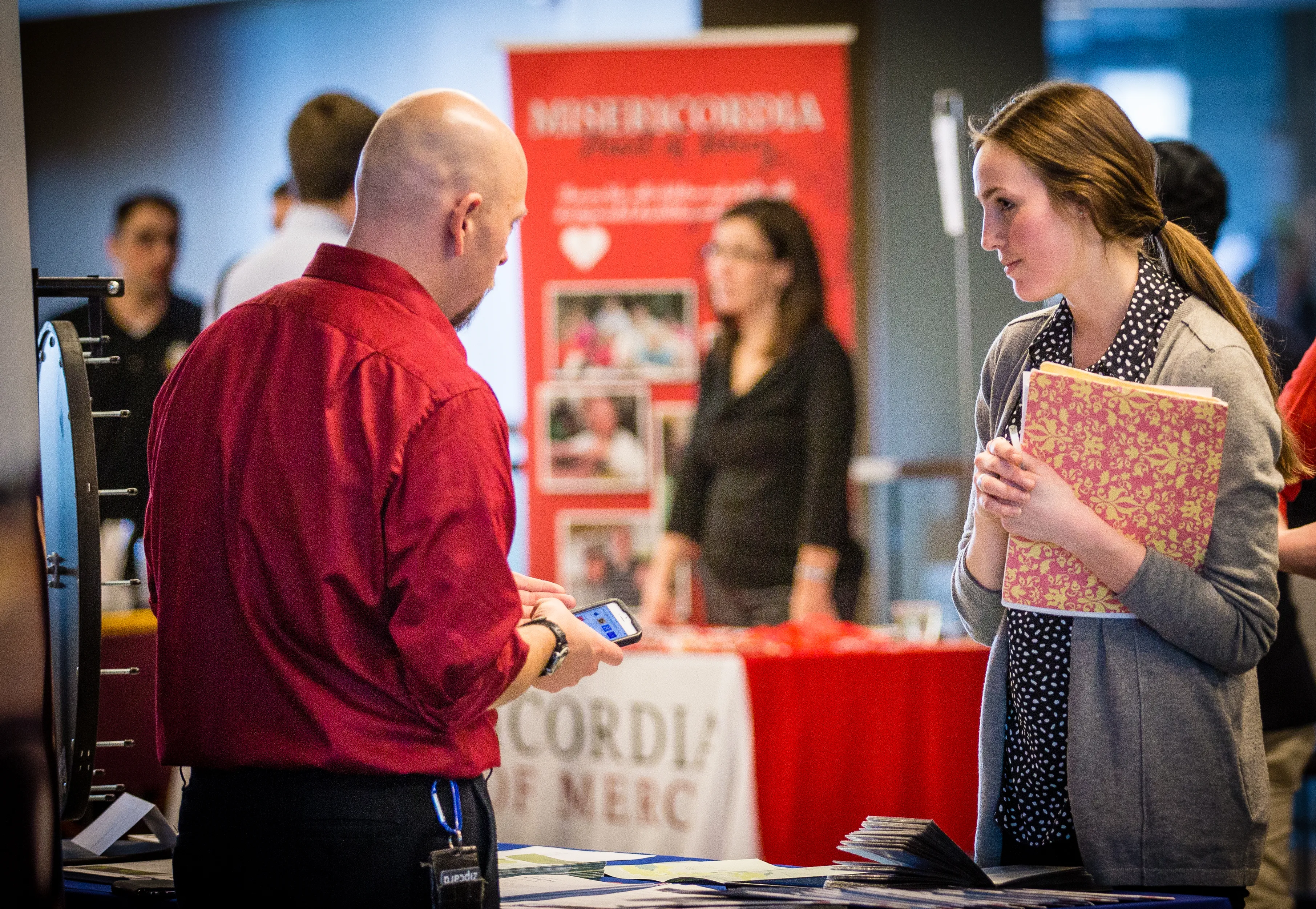 Loyola University Chicago student speaking with employer at campus job fair