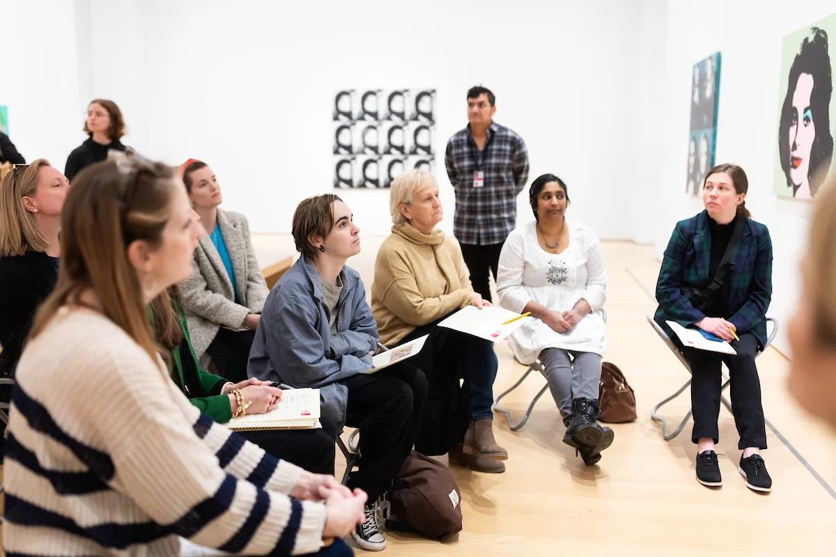 Students discussing artwork Students discussing artwork