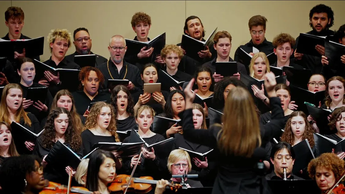 A group of Loyola Choir and Orchestra students performing in JoAnn Rooney Hall, conducted by DFPA Chair Kirsten Hedegaard. A group of Loyola Choir and Orchestra students performing in JoAnn Rooney Hall, conducted by DFPA Chair Kirsten Hedegaard.
