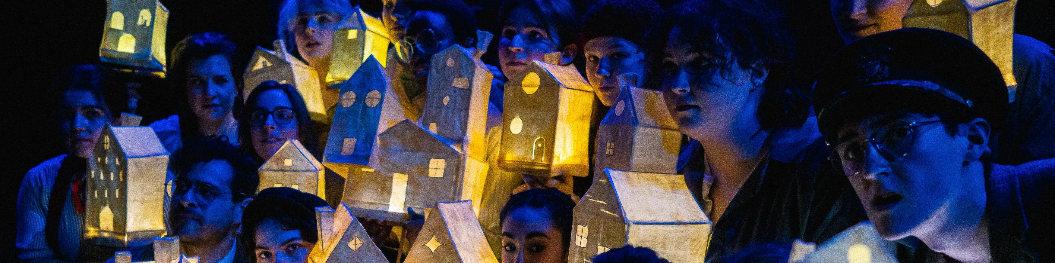 Loyola Theatre students holding lantern houses on the Newhart Family Theatre Stage