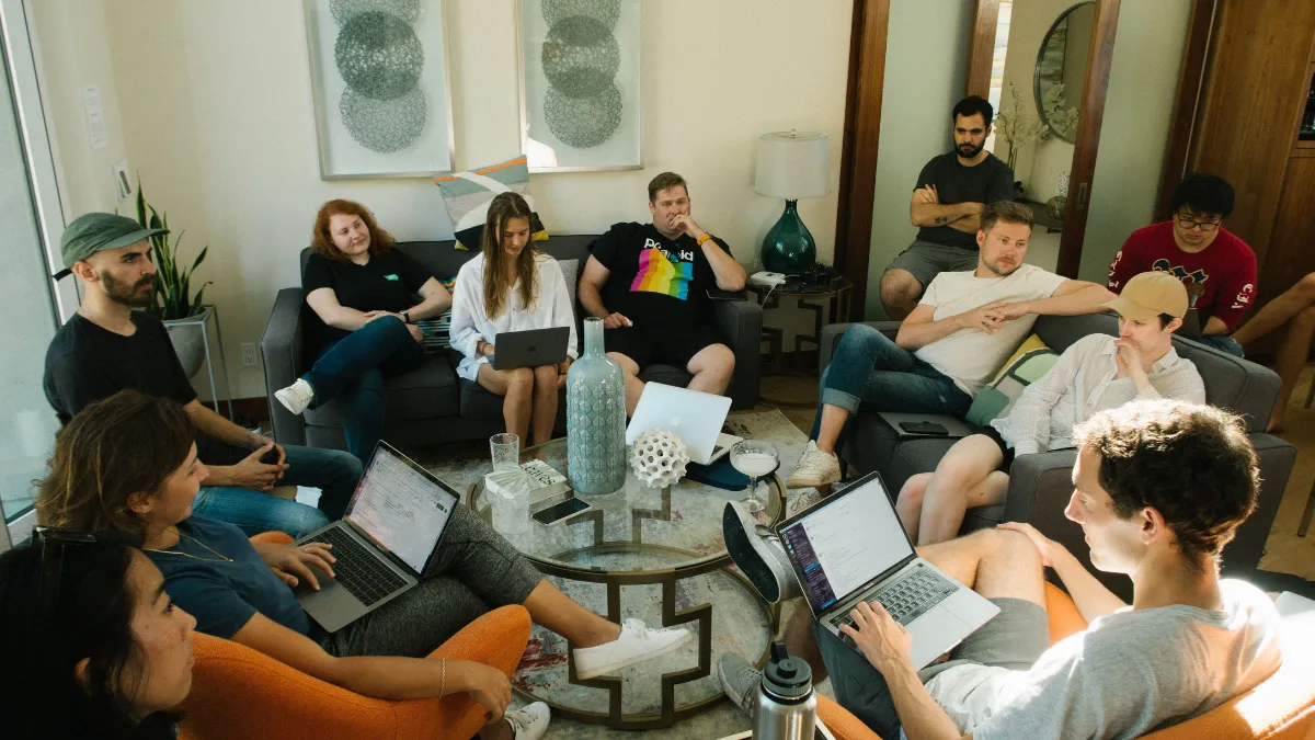 A ring of students and scholars sit together to discuss AI policies
