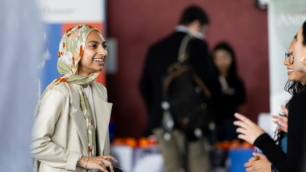 Young woman smiles during a Loyola University Chicago-hosted event