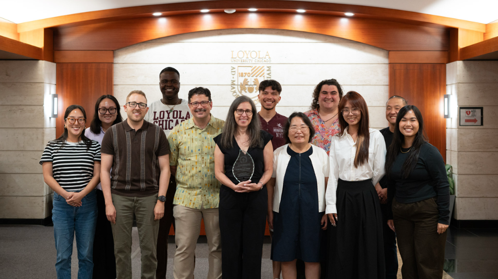 Elizabeth Vera, professor and co-chair of the program, holds CPSY award with fellow faculty members and students in program. Elizabeth Vera, professor and co-chair of the program, holds CPSY award with fellow faculty members and students in program.