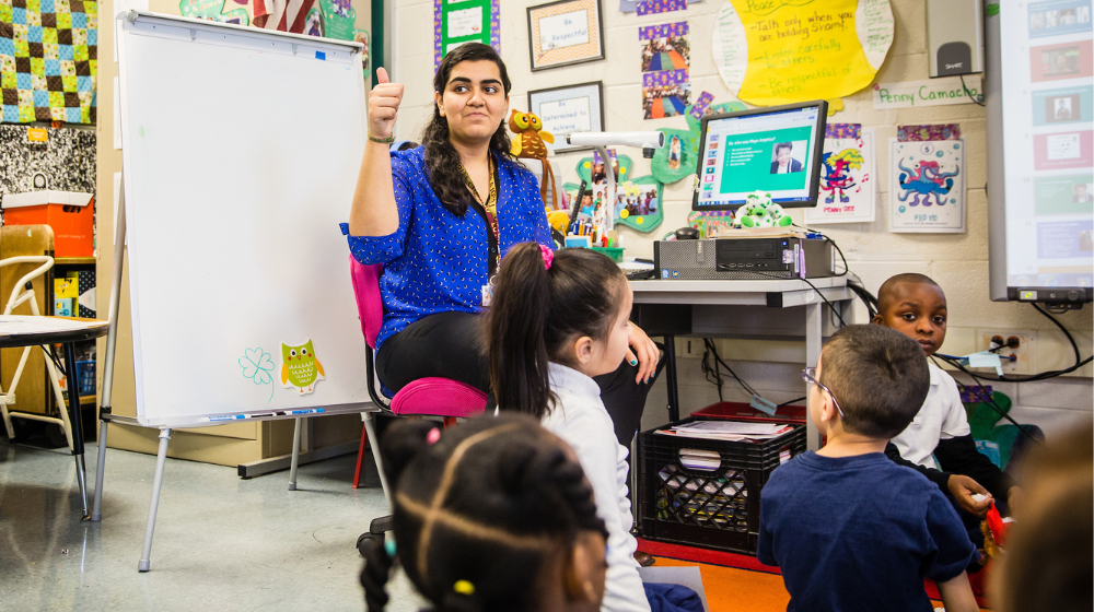 Armeen Sayani is sitting in class with students Armeen Sayani is sitting in class with students