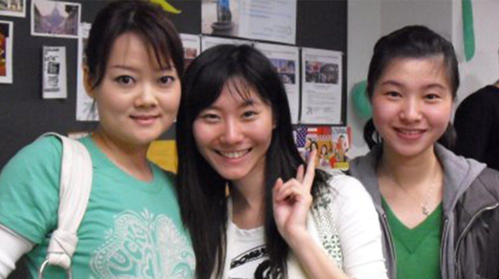 Three ESL students gather for a group photo