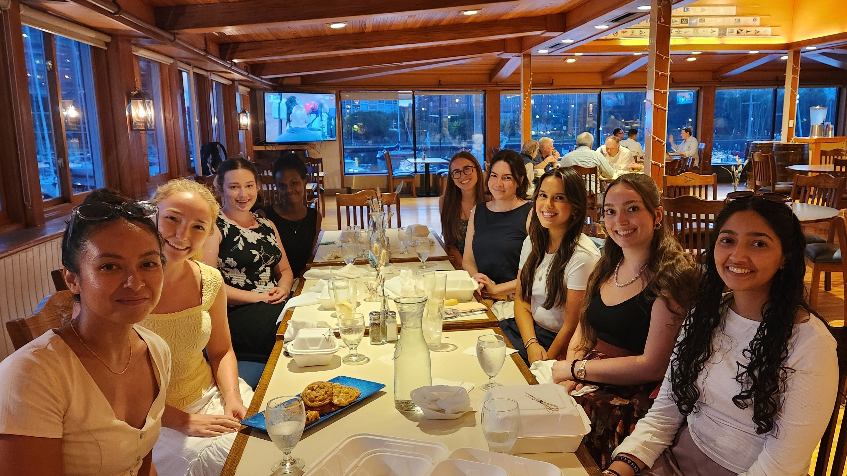 Gannon Scholars sit around a long table at the Chicago Yacht Club Gannon Scholars sit around a long table at the Chicago Yacht Club
