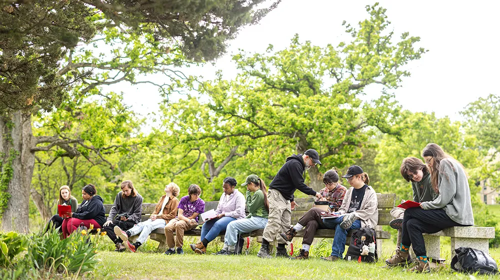 Ray Dybzinski, associate professor in the School of Environmental Sustainability, shows students how to use equipment that measures soil and plant
