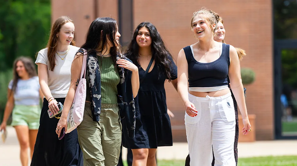 A group of Loyola students walking outdoors at the Rome Center