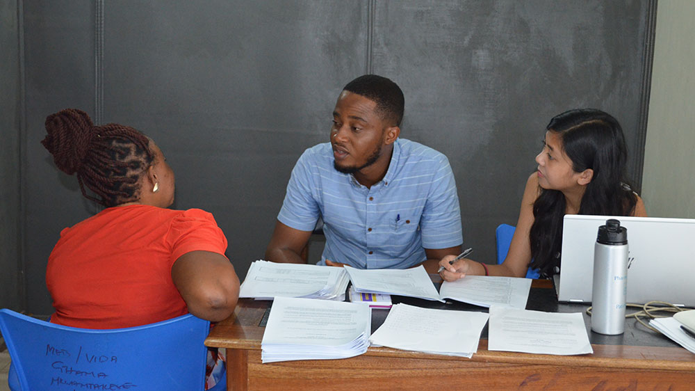 A Loyola University Chicago School of Sustainability student checks a reading on a home in a Chicago area neighborhood.