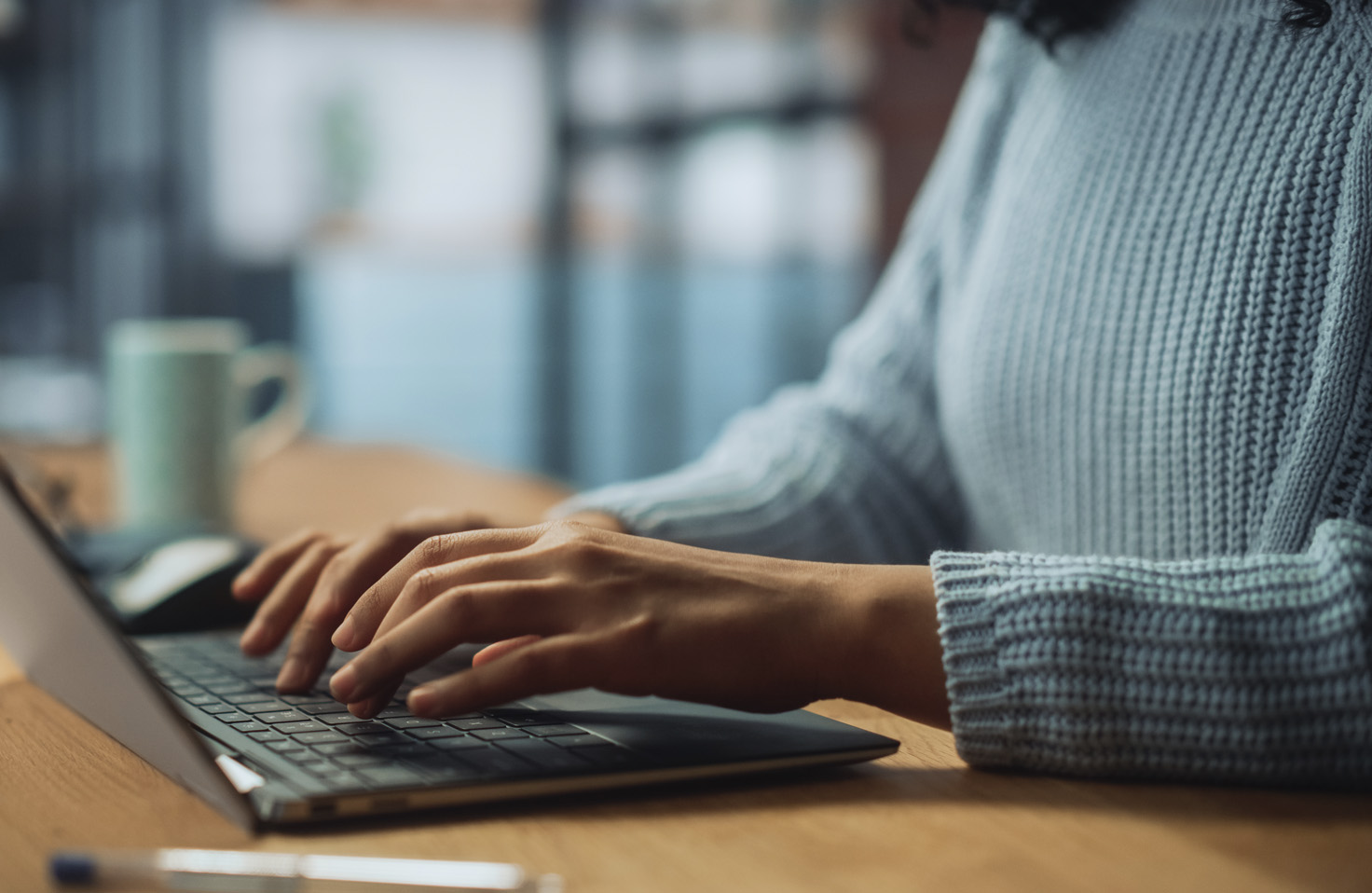 Two individuals working on a Qualtrics survey on a laptop