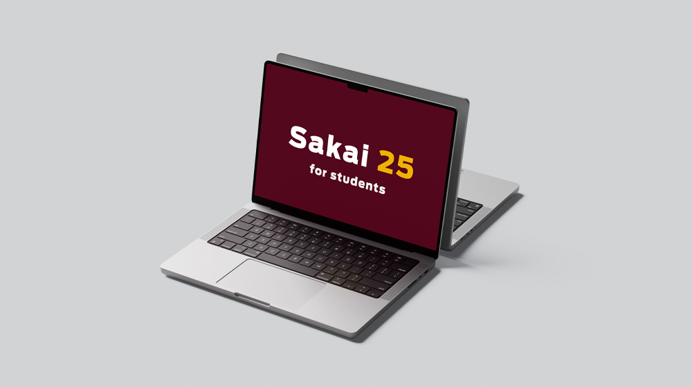 Two laptops facing back-to-back with one monitor displaying 