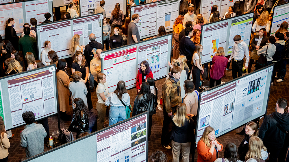 Students gather and present their research posters at the annual URES Poster Symposium event.