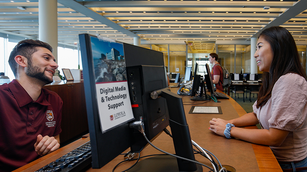 A student receiving technology support from our Information Commons service desk.