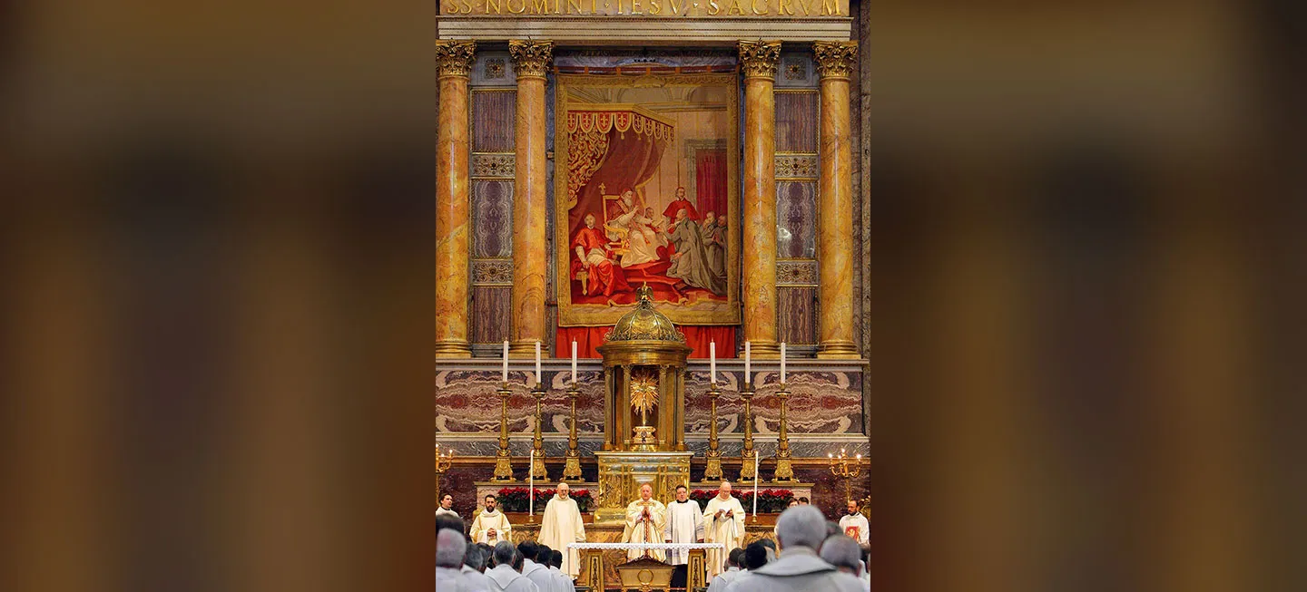 Several Jesuits standing behind an alter.