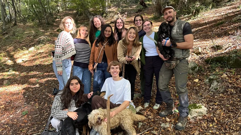 Students pose with truffle hunters and dogs