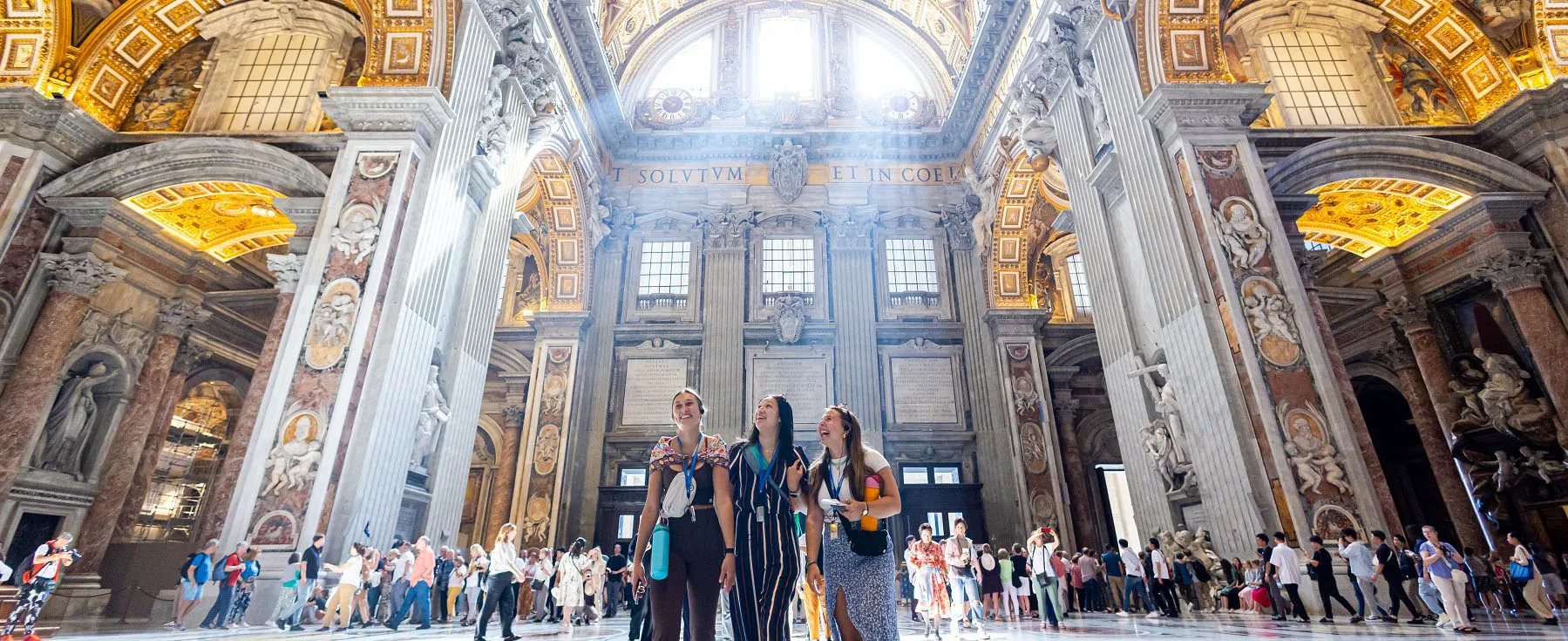 Students admire the ceiling of St Peter's Basilica during an onsite class