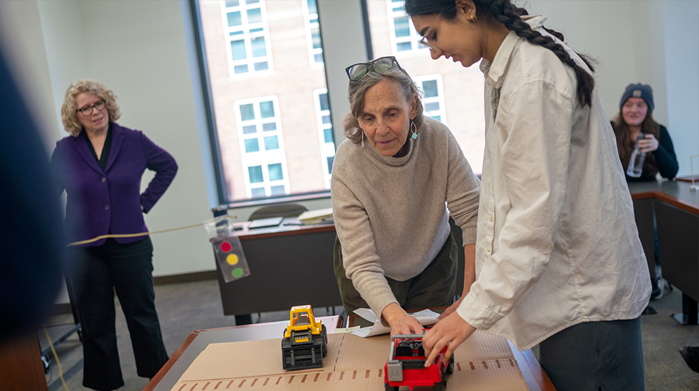 Legislation and Policy Clinic director Anita Weinberg and student Isra Rahman work with a faculty-created model of a traffic intersection Legislation and Policy Clinic director Anita Weinberg and student Isra Rahman work with a faculty-created model of a traffic intersection