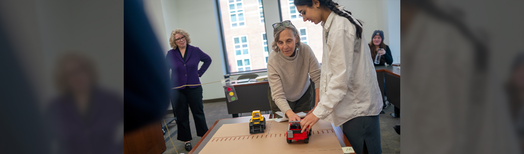 Legislation and Policy Clinic director Anita Weinberg and student Isra Rahman work with a faculty-created model of a traffic intersection to simulate the complexities of legislative drafting.
