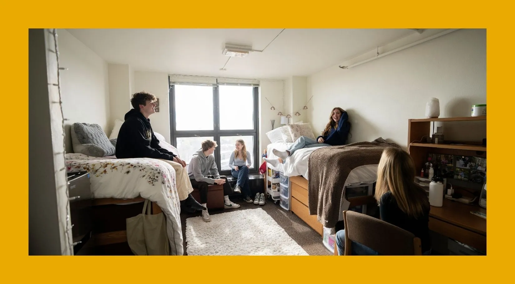 Students hanging out in a dorm room. 