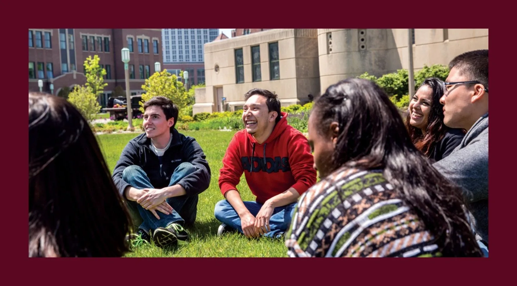 Students sitting in a circle outside. 