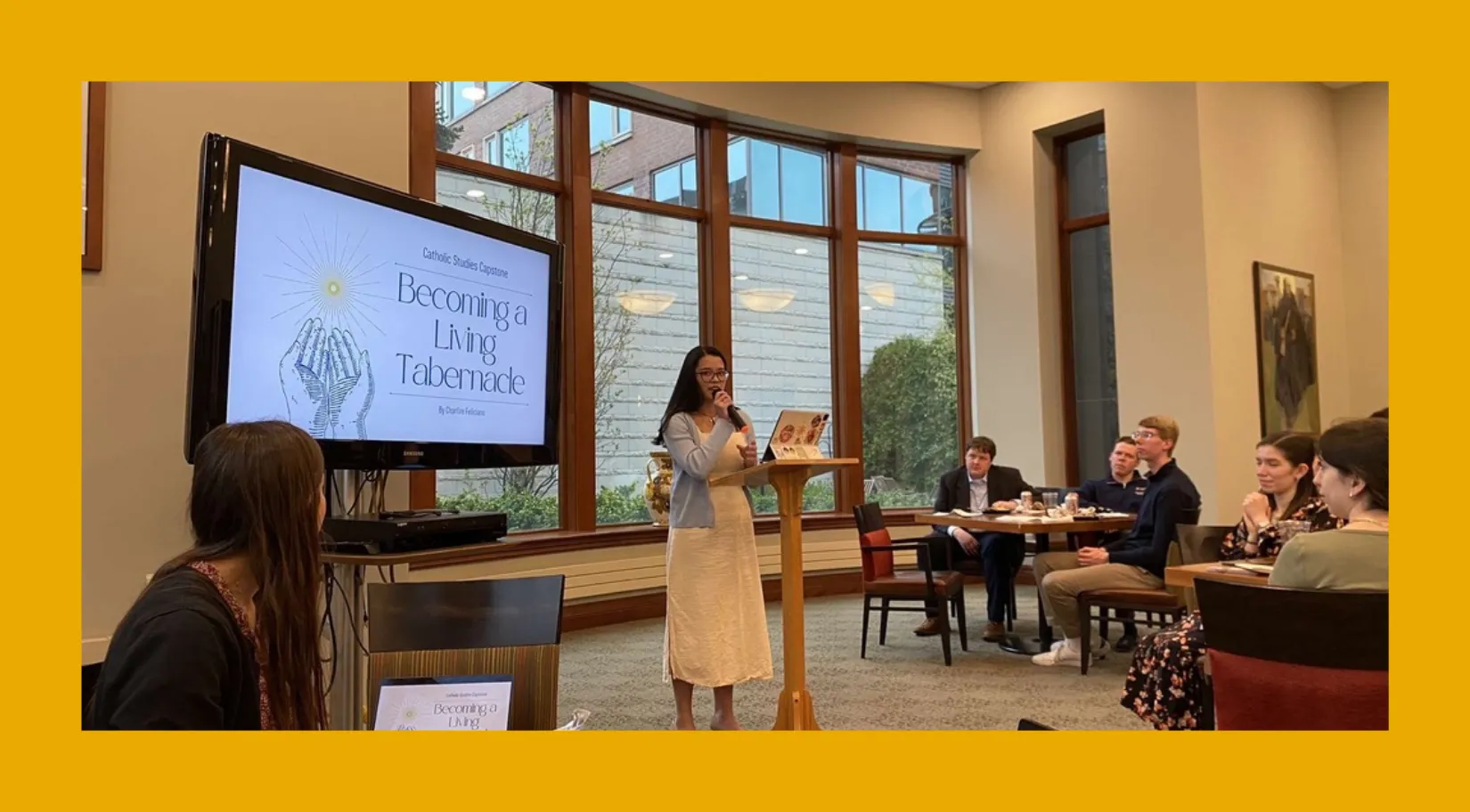 A woman giving a presentation. 