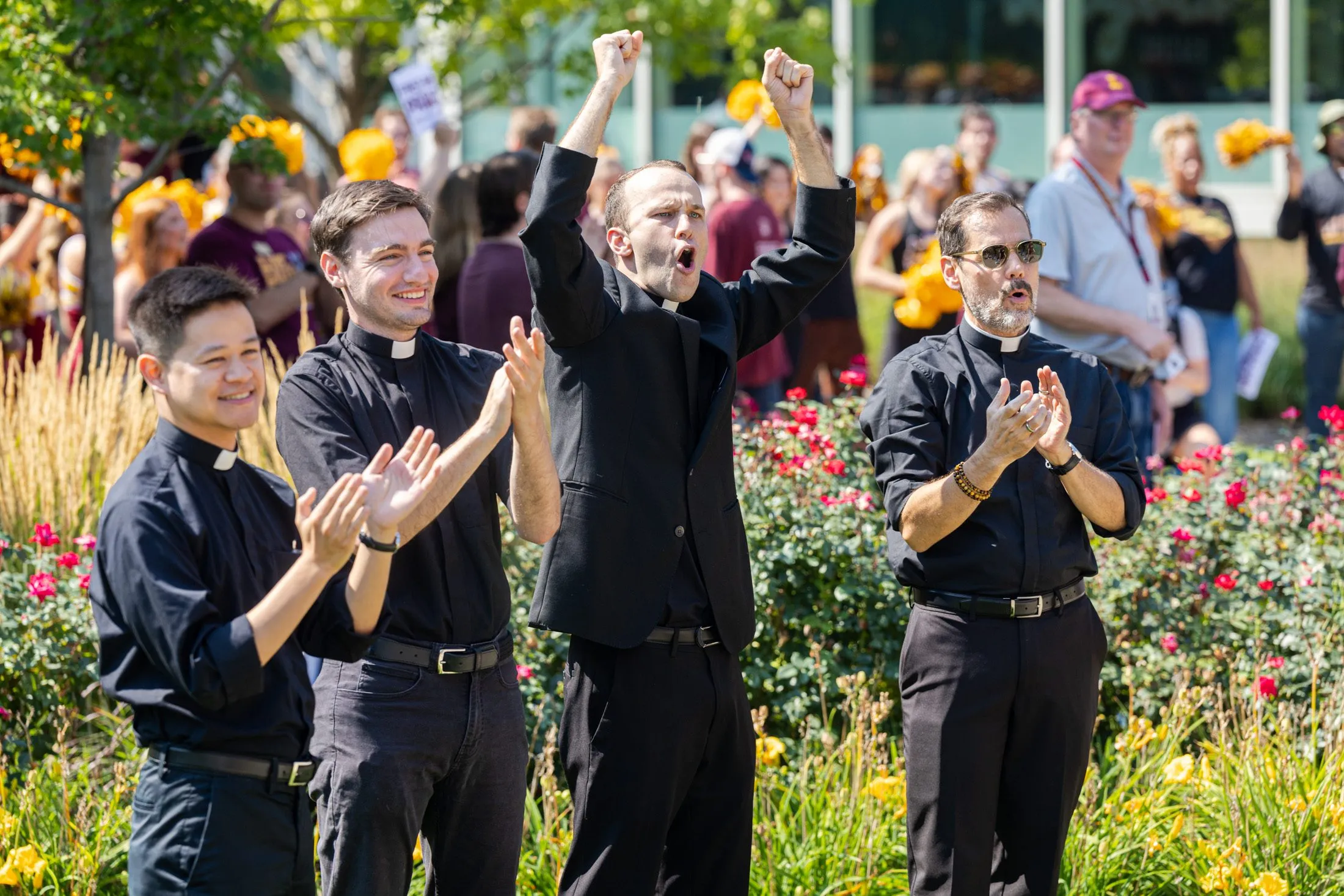 Jesuits cheering at event