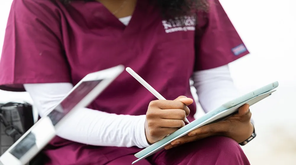 Loyola nursing student writing Loyola nursing student writing