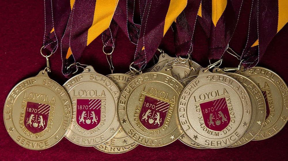Gold medallions with Loyola's shield on them