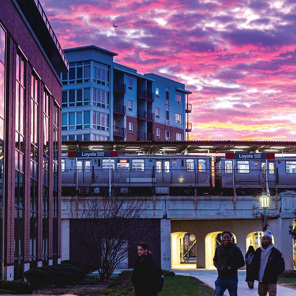 Loyola University Chicago lake shore campus at sunset with an L Train in the background