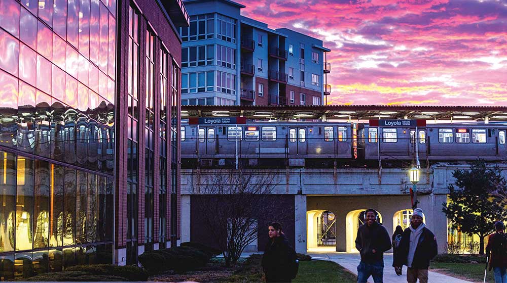 Loyola University Chicago lake shore campus at sunset with an L Train in the background