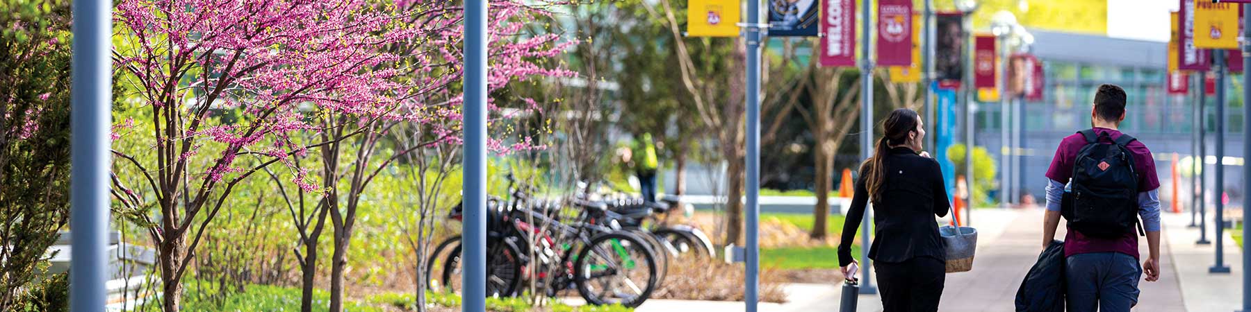 Two Loyola University Chicago students walk the Health Sciences Campus during spring