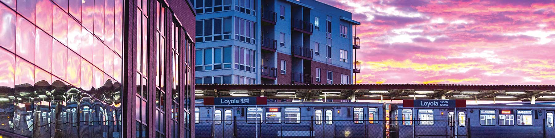 Loyola University Chicago lake shore campus at sunset with an L Train in the background
