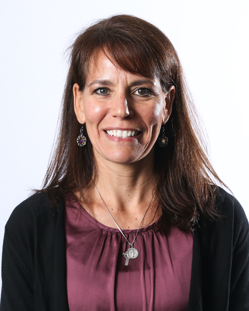 Patricia Sheean smiling in front of a white background