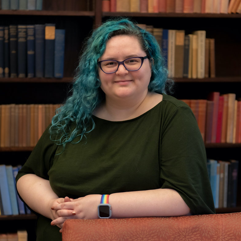 Tara Casebolt sitting in front of a bookshelf