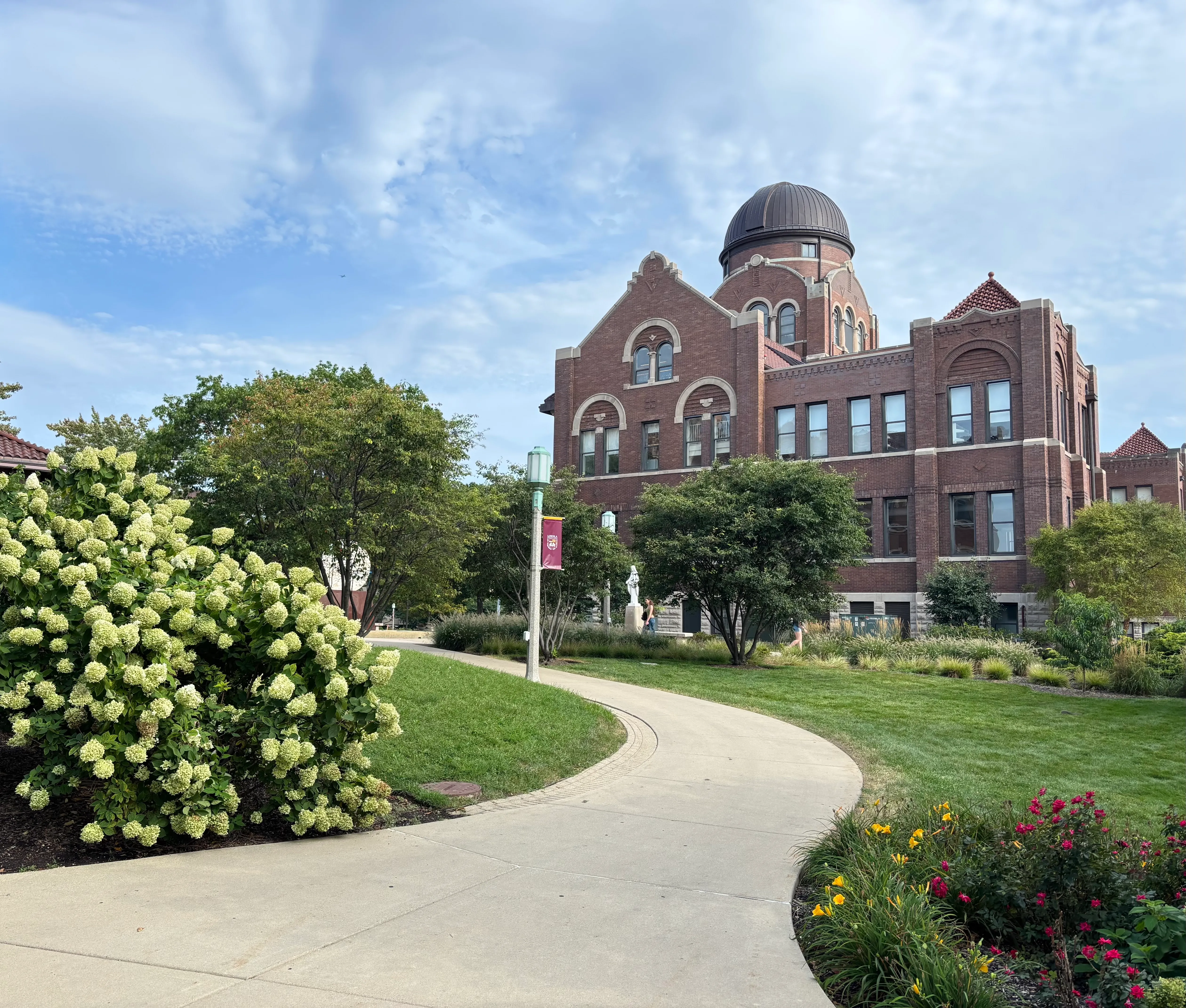 View of Lake shore campus, with greenery and a sidewalk facing lake Michigan. View of Lake shore campus, with greenery and a sidewalk facing lake Michigan.