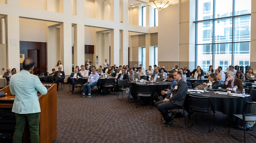 Crowd of people listening to speaker at AI in Financial Services 2025